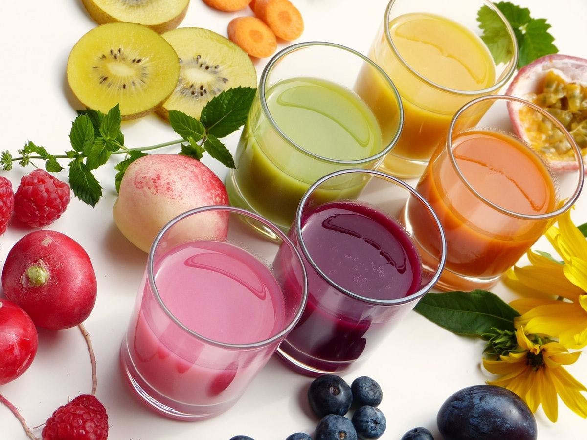 A selection of brightly colored fruit juices and smoothies by Silviarita via Pixabay