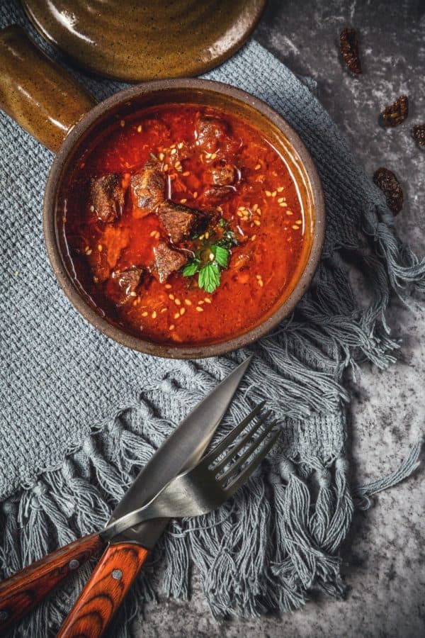 Spicy curry bowl with fork and knife