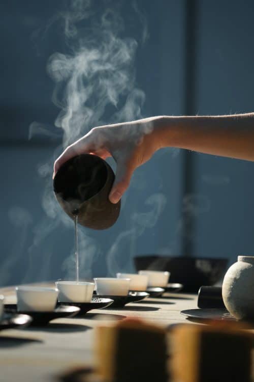 Woman pouring green tea