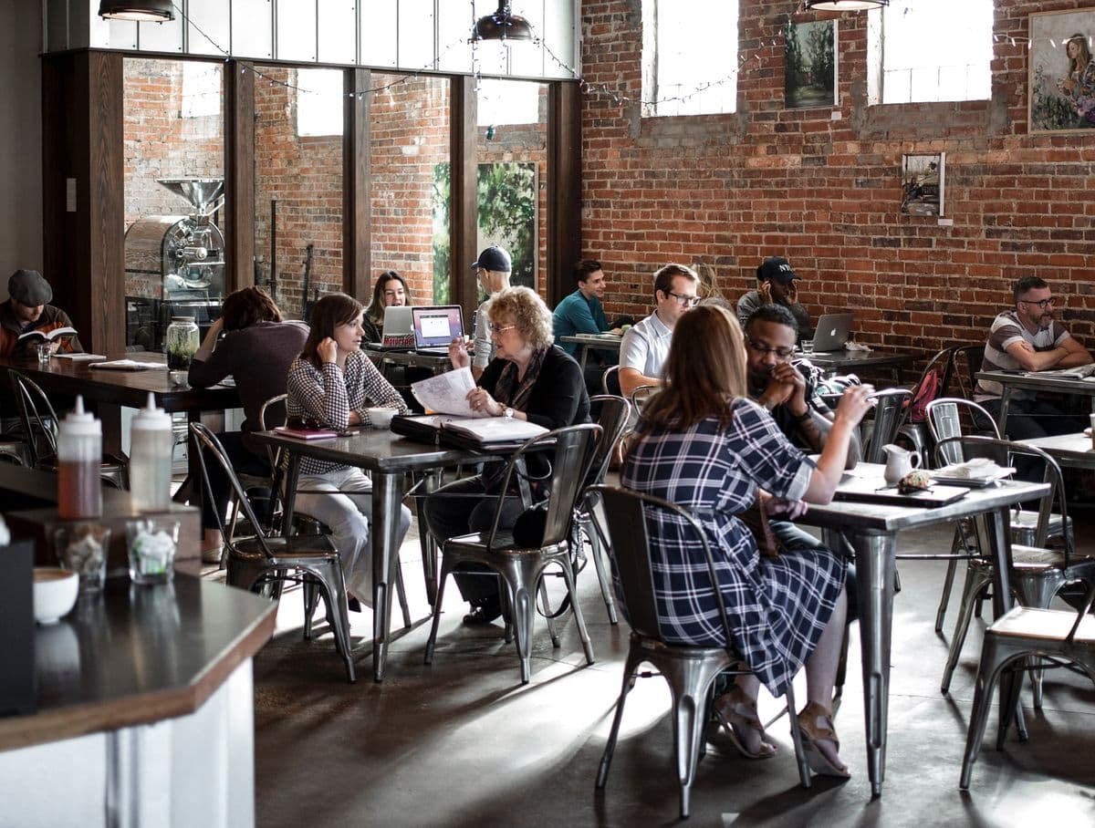 People sitting at a cafe or cafeteria, by Wade Austin Ellis via Unsplash