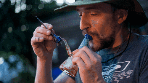 Man smoking hashish with a water pipe