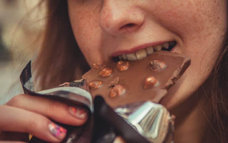 Woman eating a chocolate bar