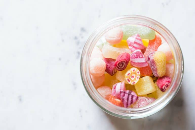 Glass container with cannabis hard candies