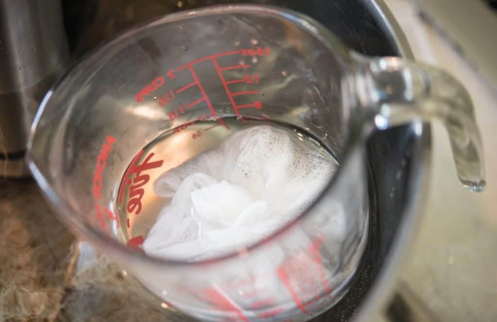 cheese cloth inside a pyrex measuring cup