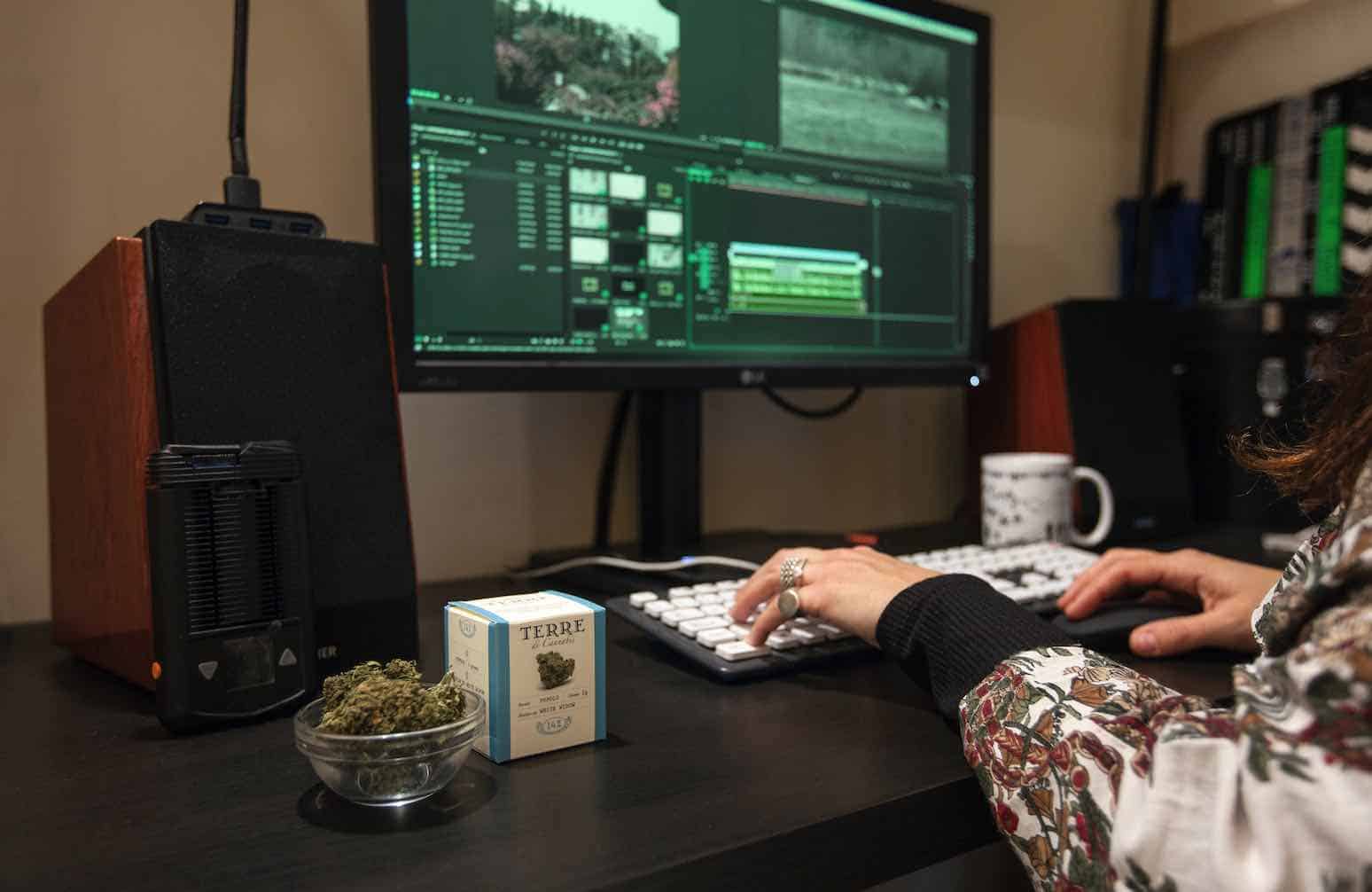 woman at desk with cannabis