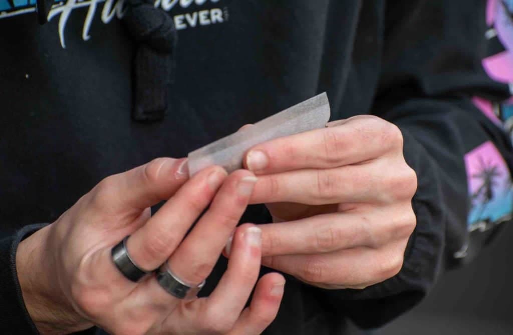 young man rolling a joint