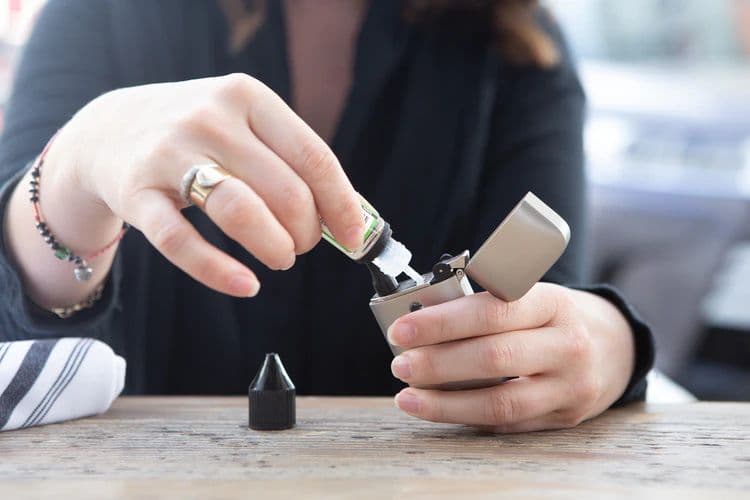 A woman loading her vape battery