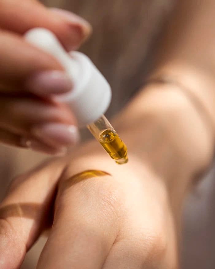 Woman applying oil on top of her hand