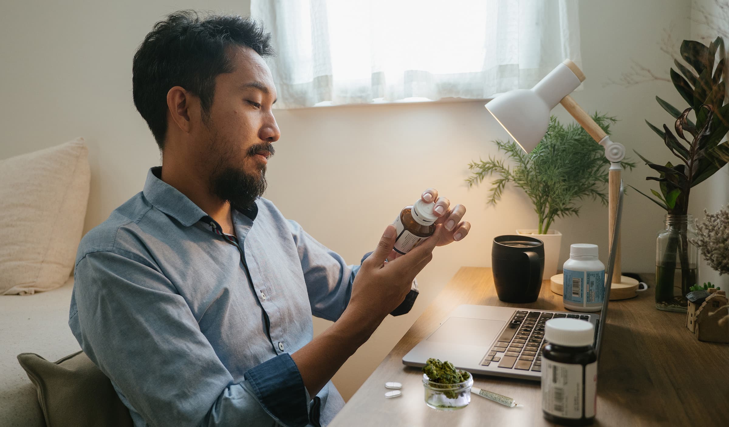 Man sits at his desk with cannabis and opioids