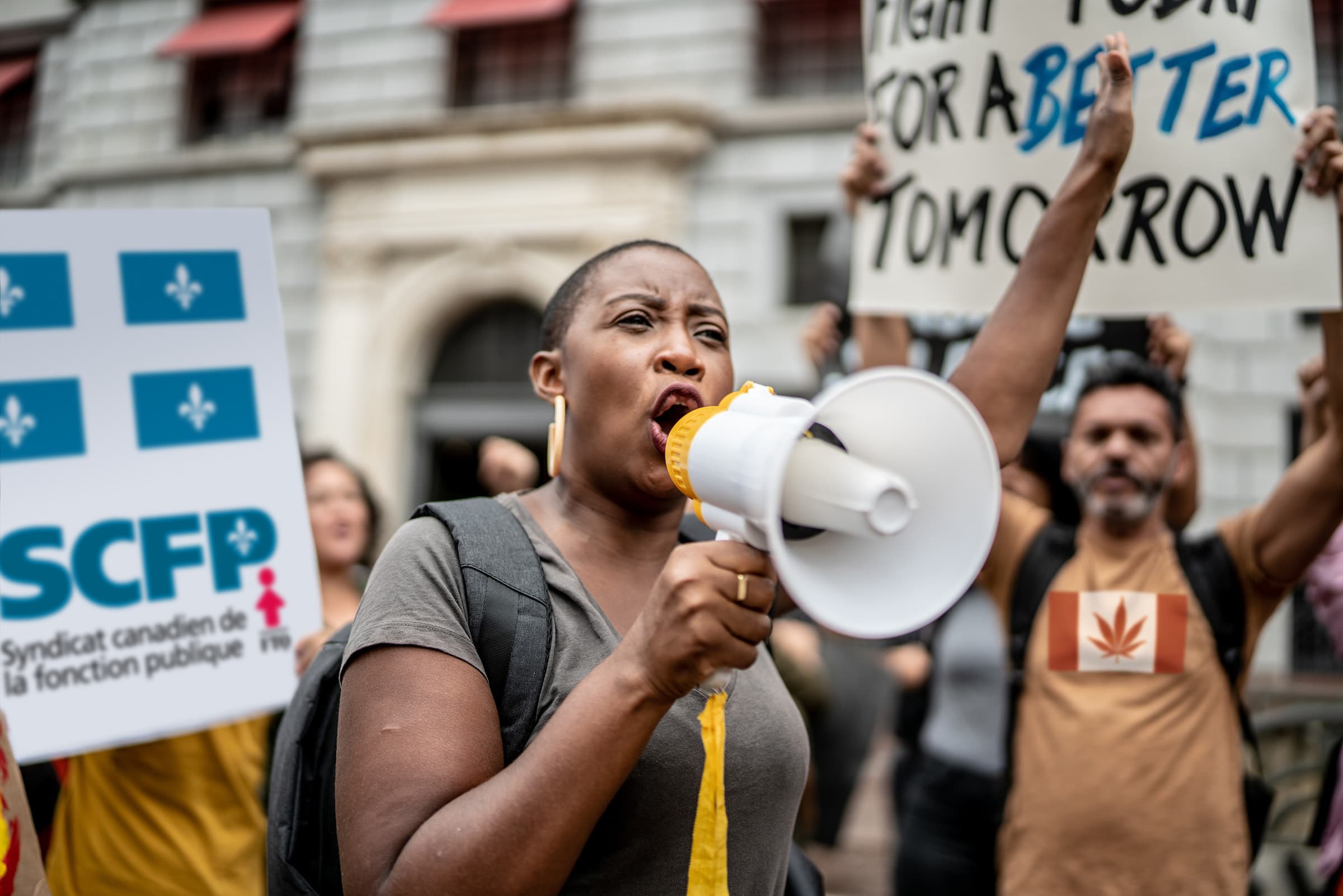 woman with megaphone representing demands for workers rights