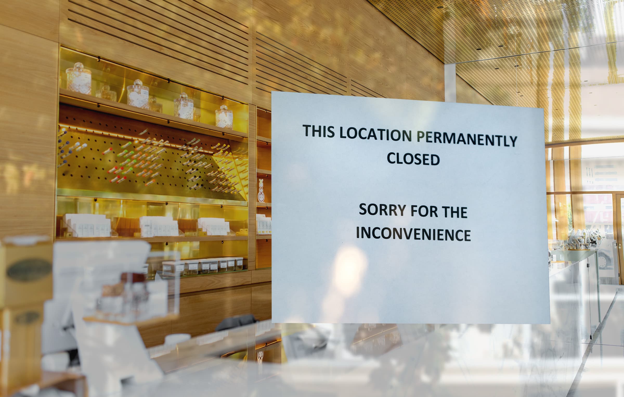 A sign on the door of a retail cannabis store reads that it's closing