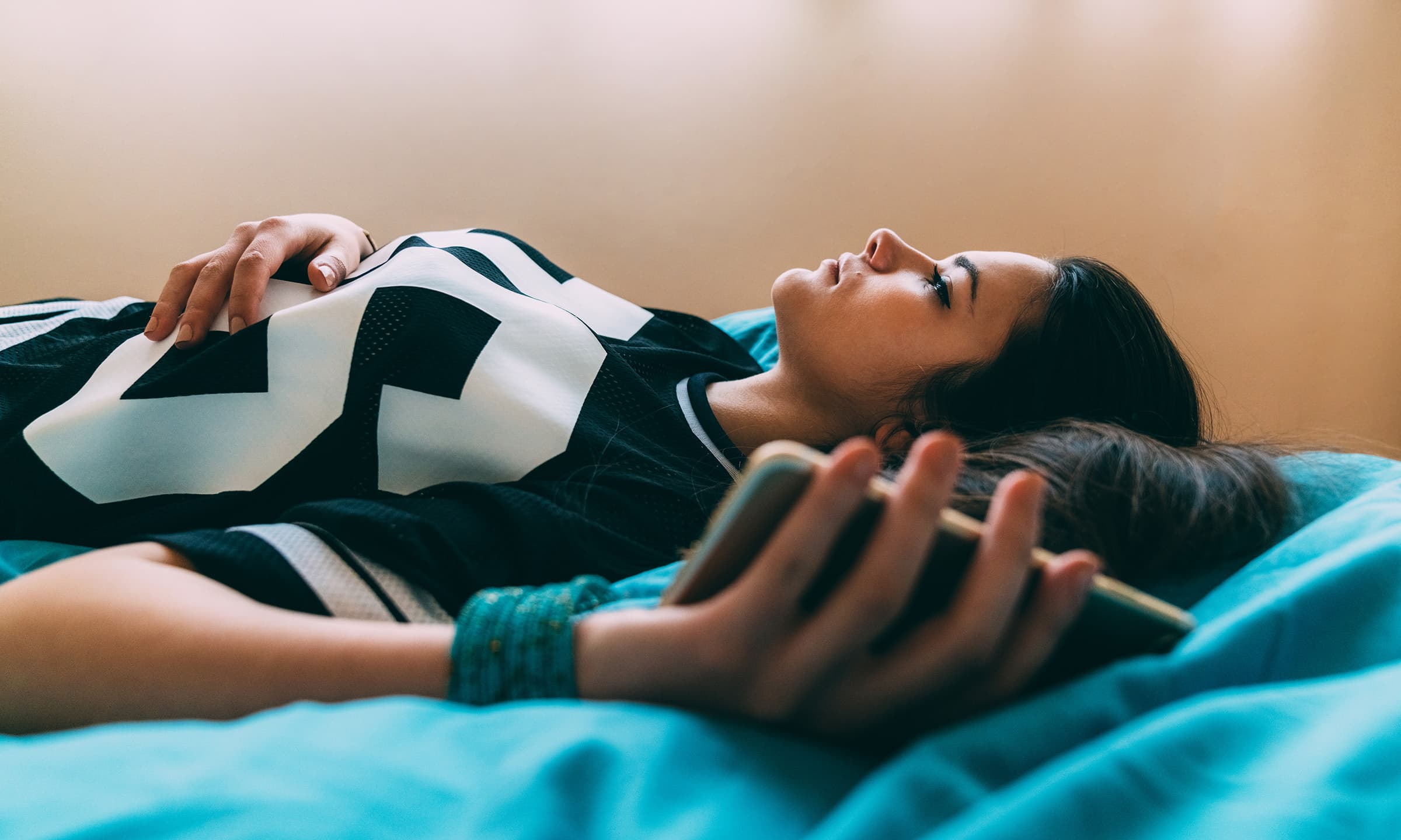 woman laying in bed looking sad