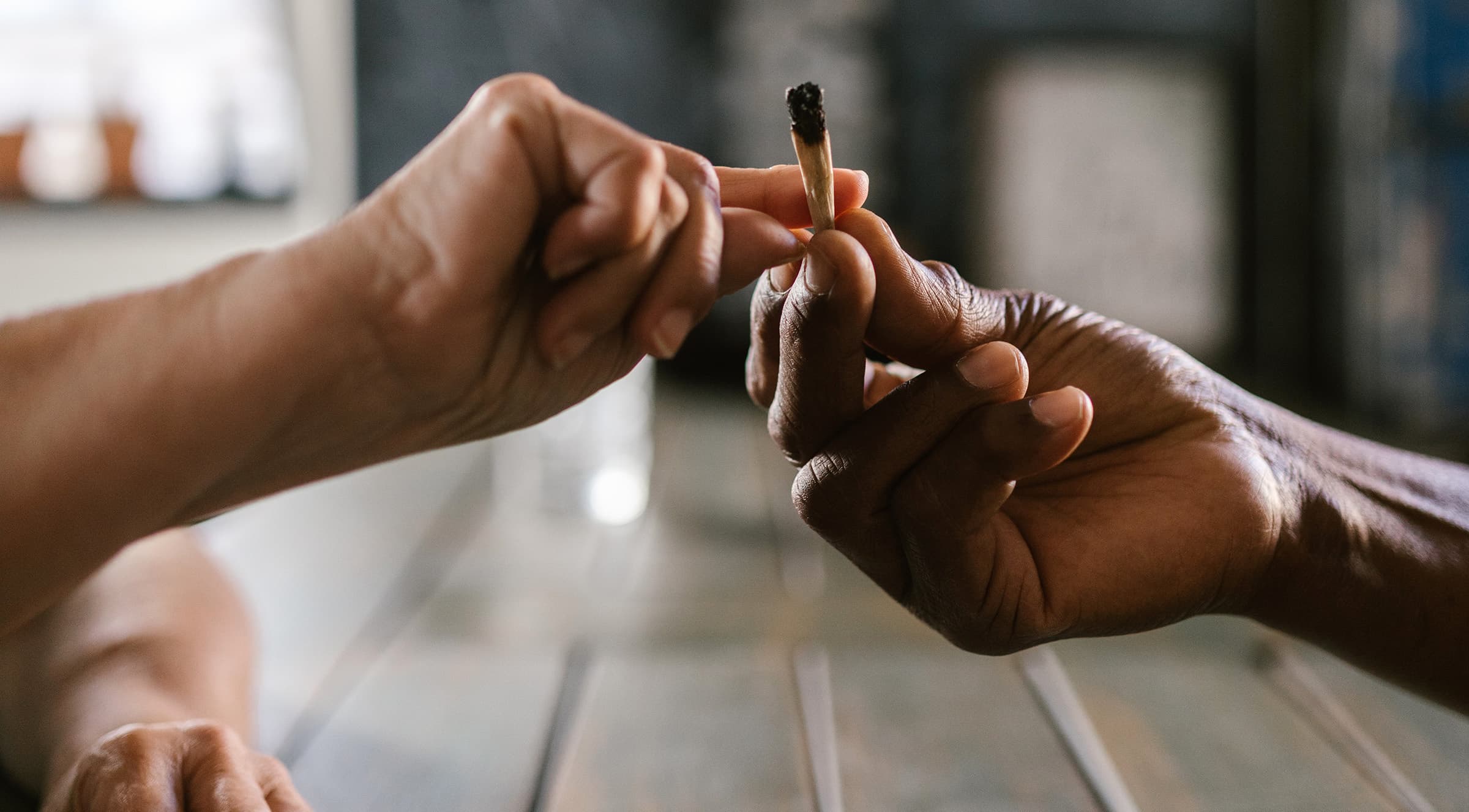 two hands passing a joint