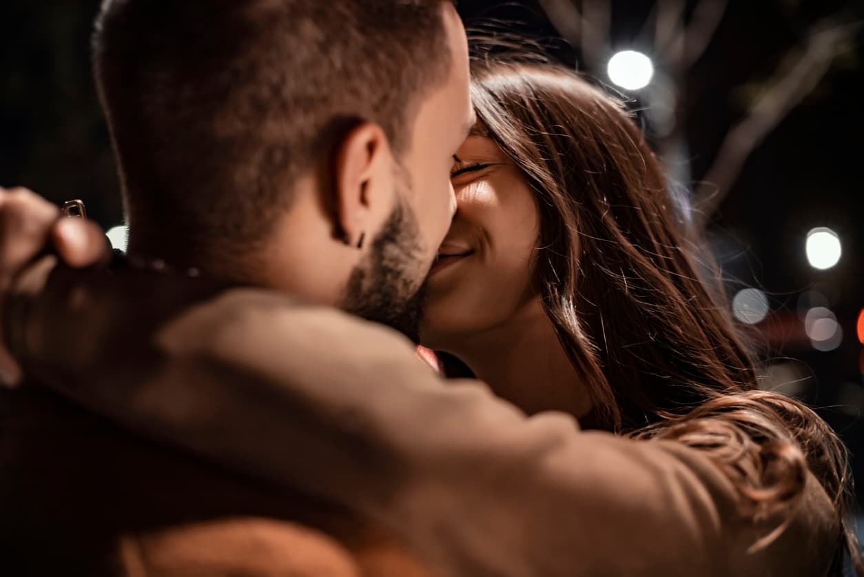 Passionate Lovers Sexually Kissing and Embracing in Evening City Street . Modern Woman and Man Romantic French Atmospheric Moment. Shot of a Young Couple Kissing in a Downtown Street by Night