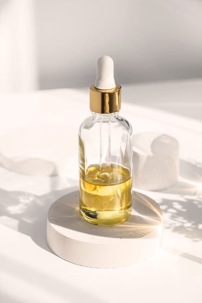 Dropper glass Bottle Mock-Up. Body treatment and spa. Natural beauty products. Eco cream, serum, skin care blank bottle. Anti-cellulite massage oil. Oily cosmetic pipette.