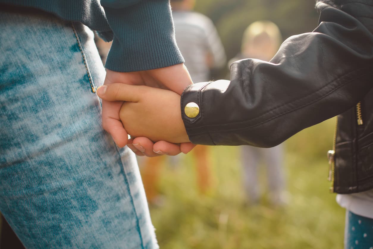 Close up of mother holding daughter's hand