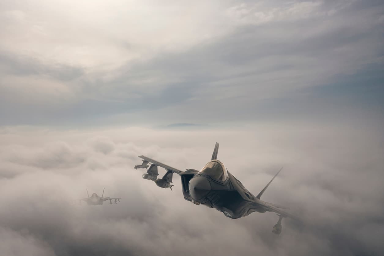 Jet aircrafts flying over the clouds.