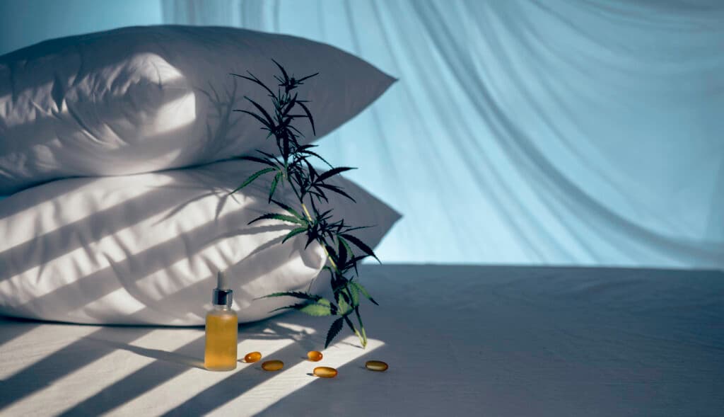 Evening bedroom with cbd oil, capsules and a cannabis branch. Melatonin production, concept to combat sleep disorders