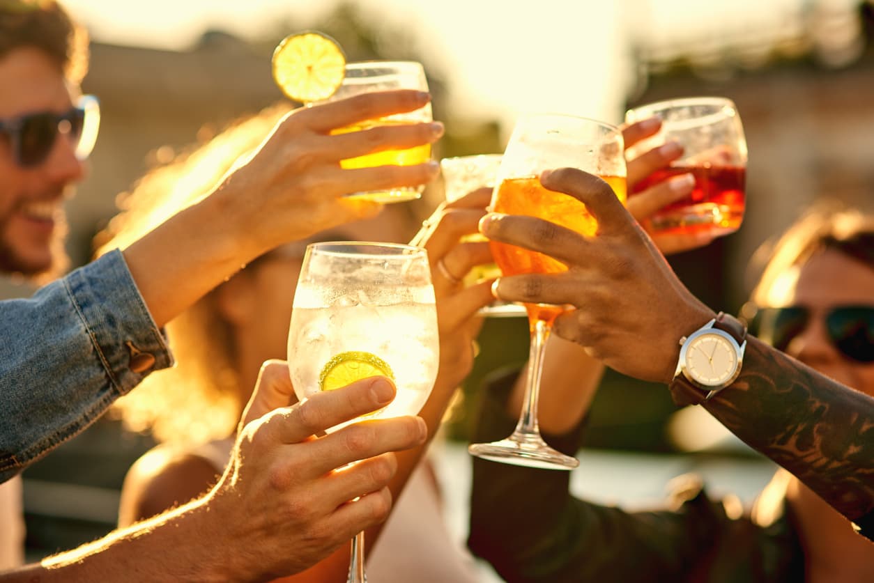 Cropped shot of a group of unrecognizable friends having a drink and spending the day outside on a rooftop