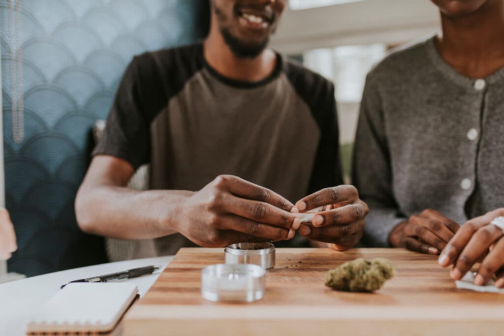 A couple rolling a joint