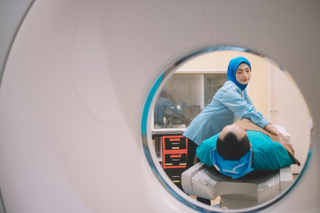 an asian malay male patient prepared for hospital CT Scan lying on the bed