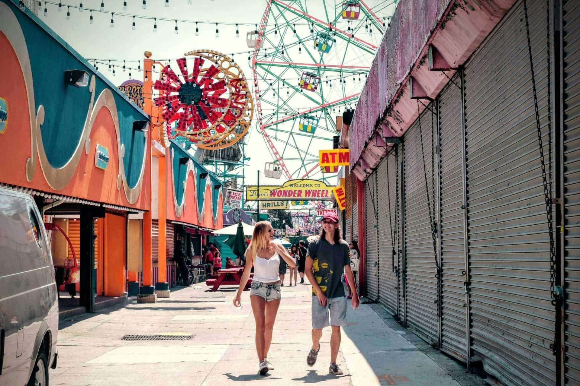 heterosexual couple walking together at a carnival.