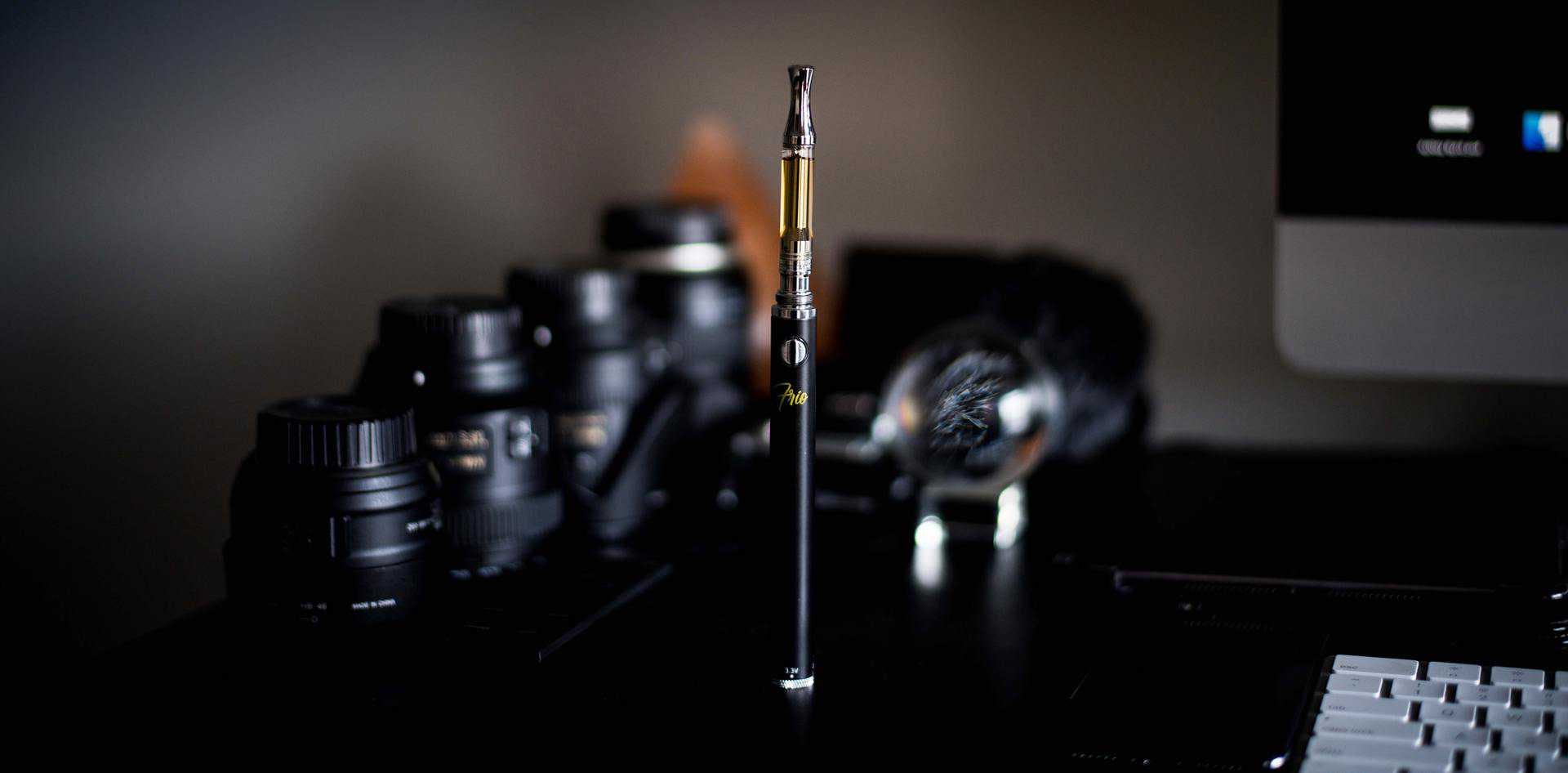 photo of a dab pen in front of camera lenses