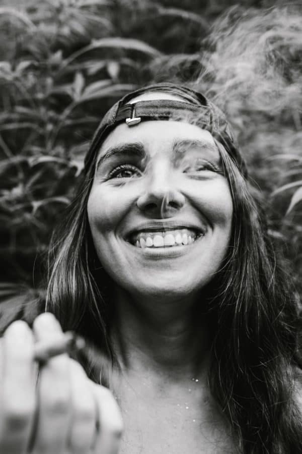 Young woman smoking a joint and smiling
