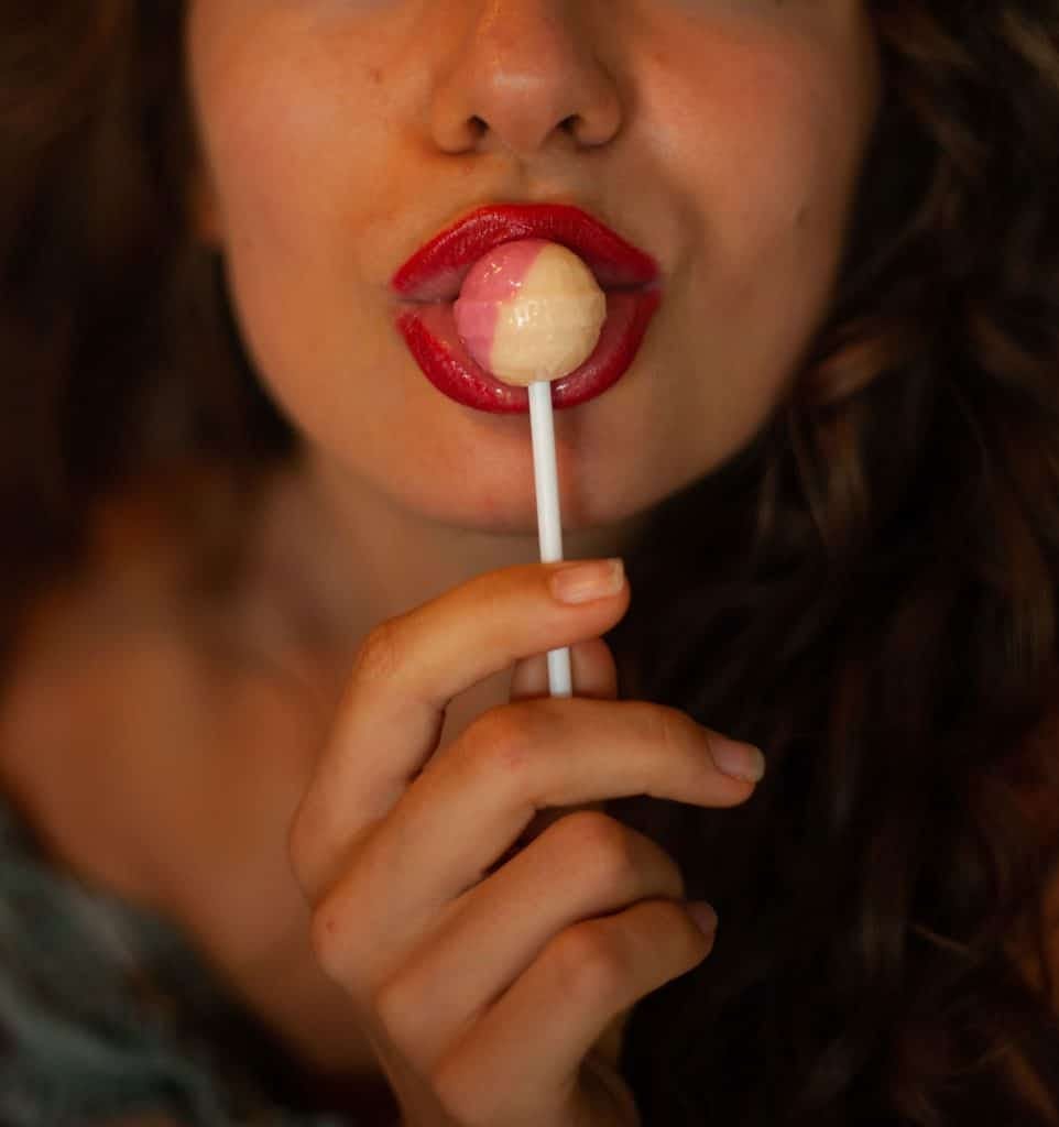 Woman licking lolli-pop