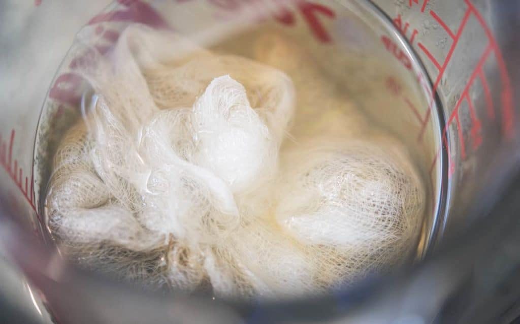 close-up image of cheesecloth inside a measuring cup