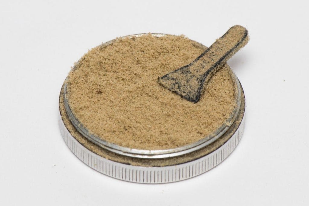 Isolated cannabis kief in a white background up close, by Zenkyphoto via iStock