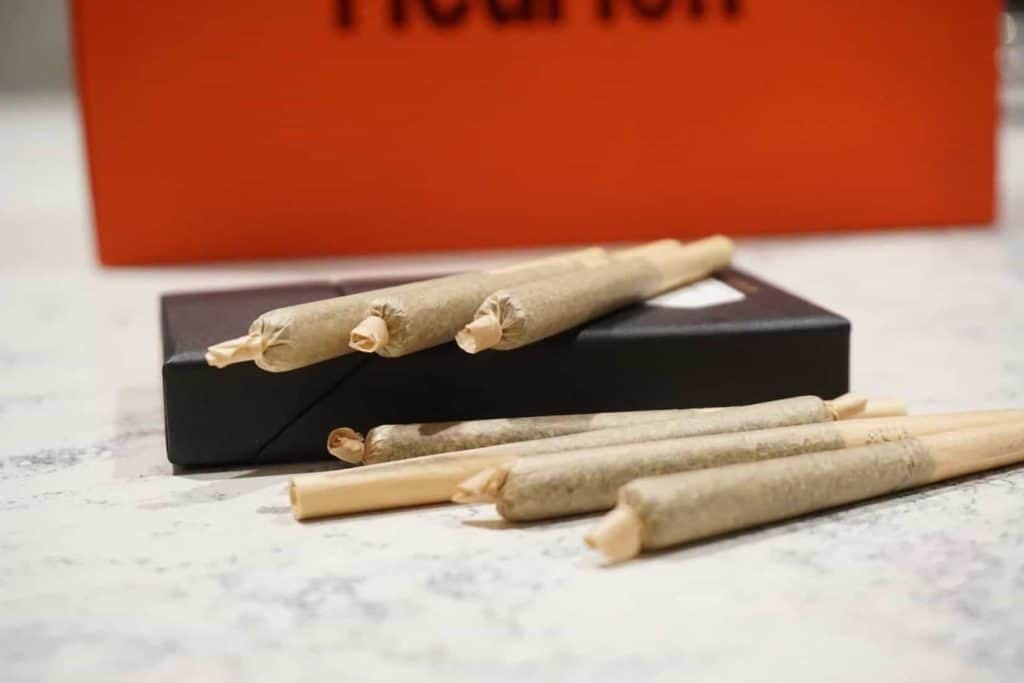 Six rolled joints laying on a table