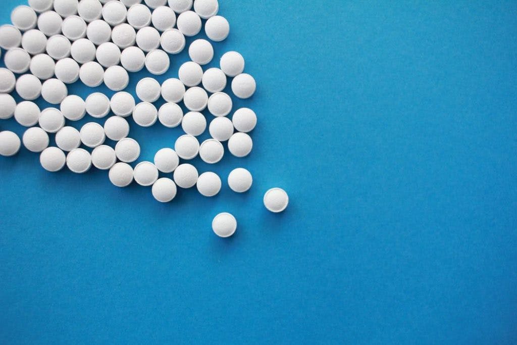 White pills against a blue background