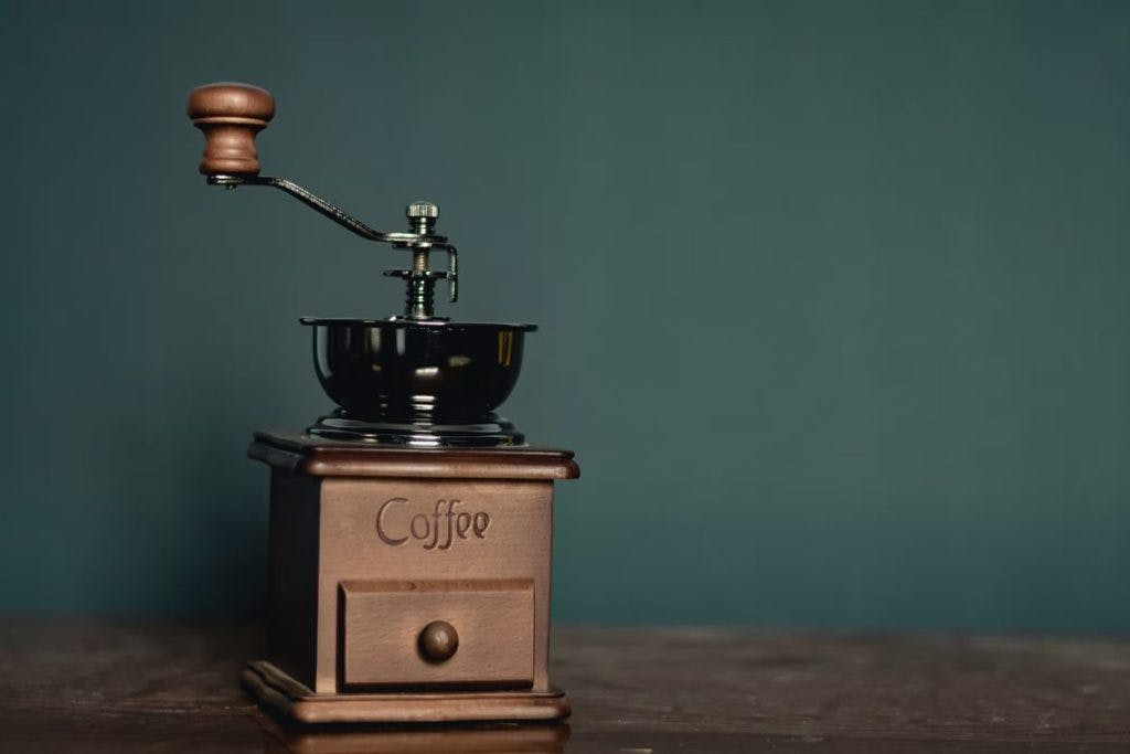 An antique coffee grinder, by Ashkan Forouzani via Unsplash