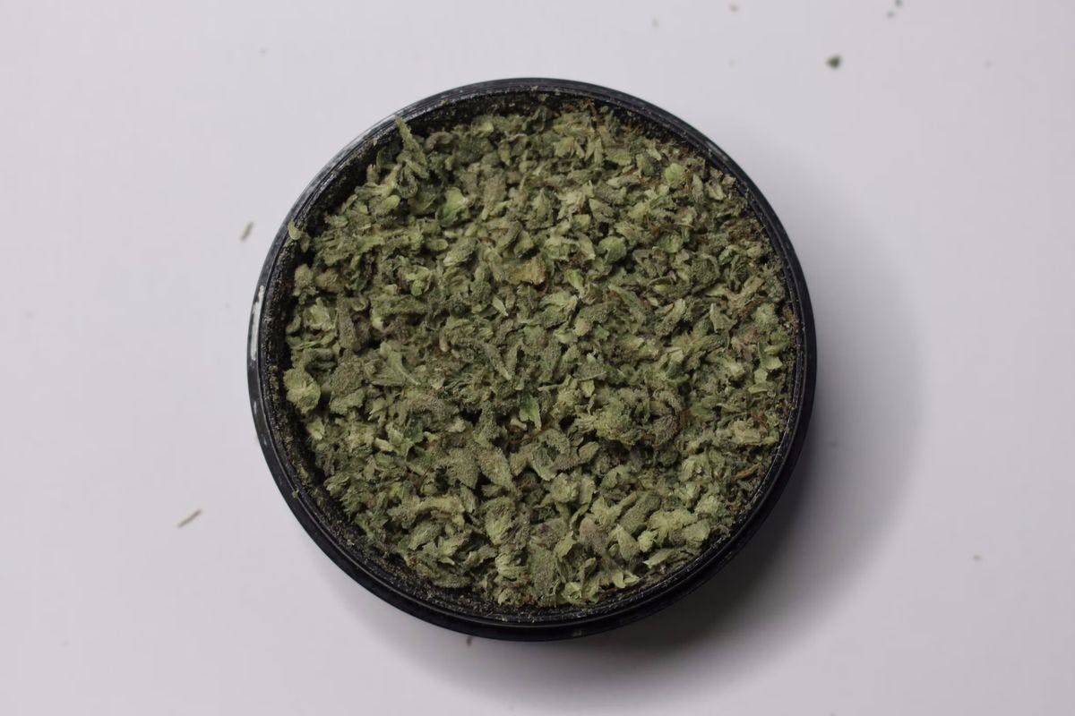 A weed grinder, filled with ground cannabis