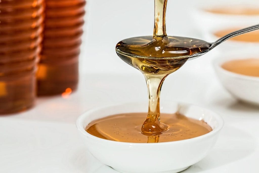 Honey being drizzled onto a spoon, being drizzled into a bowl. A lot of drizzling happening here. By stevepb via Pixabay