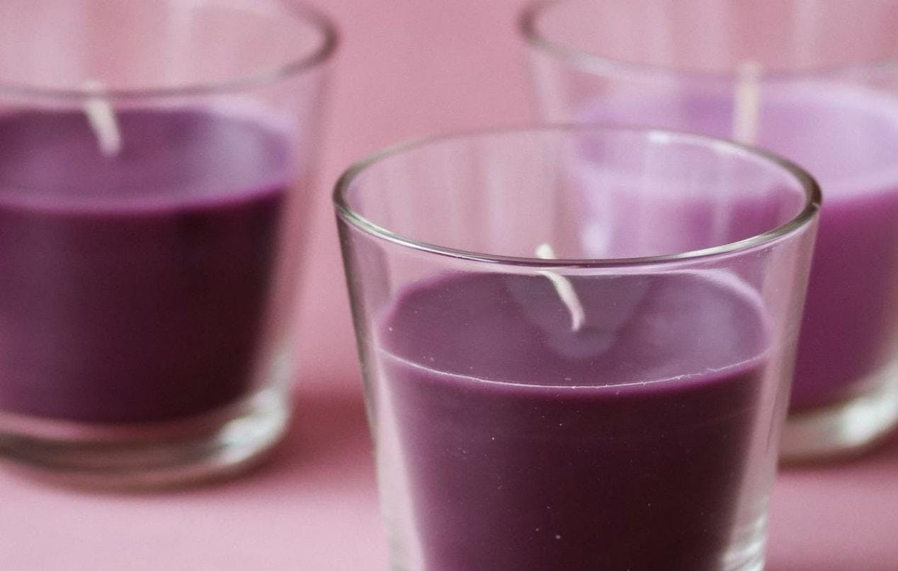A purple tea candle set, by Taisiia Shestopal via unsplash