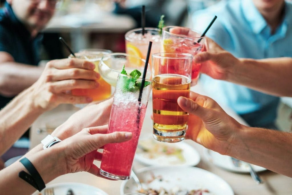 A group of hands holding drinks, by Burst via Pexels