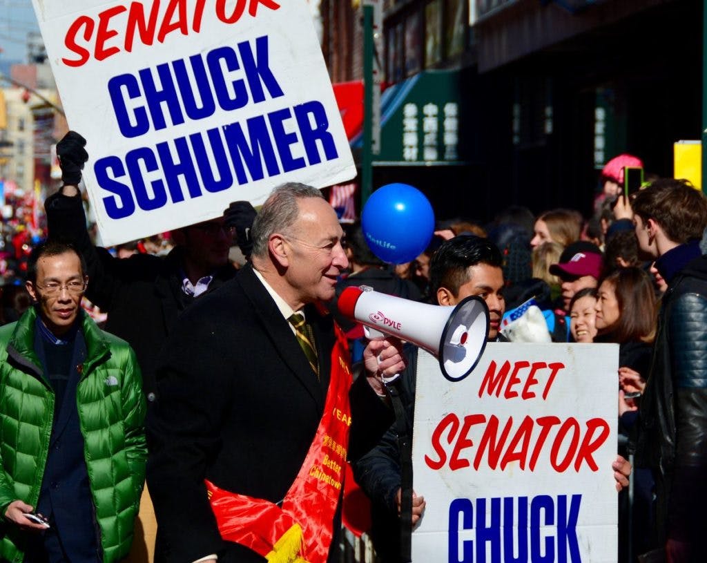 New York, USA - February 22, 2015: Senator Chuck Schumer at Chinese New Year parade in the streets of New York Chinatown. By Onnes via iStock