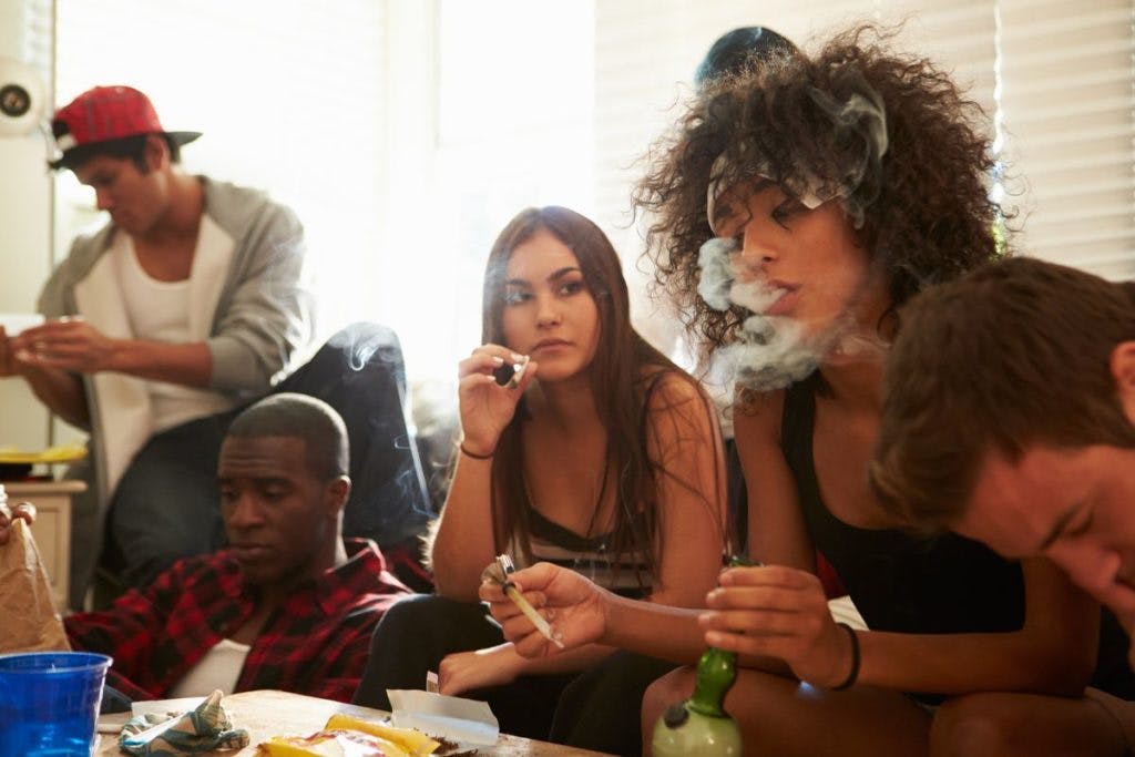 A group of people smoke weed at a party; can their cannabis consumption cause contact concern? By monkeybusinessimages via iStock