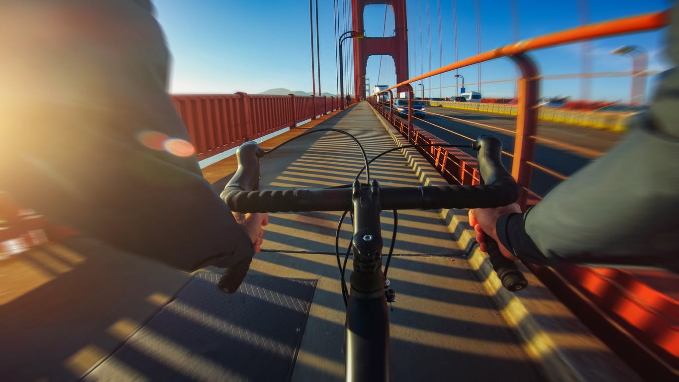 Commuter with road racing bicycle on the Golden Gate Bridge of San Francisco