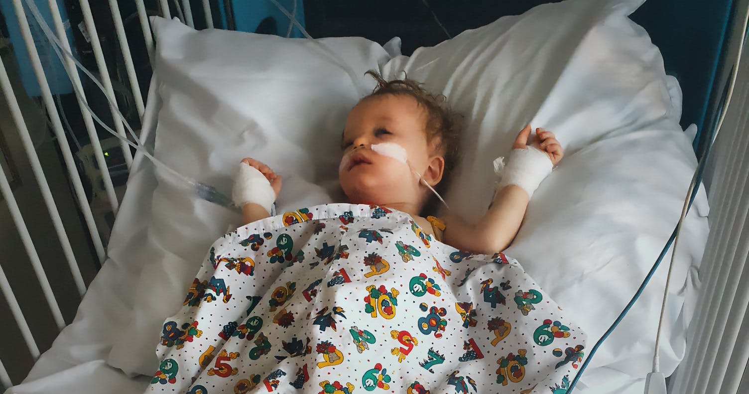 Sarah Sugden's son laying in a hospital bed