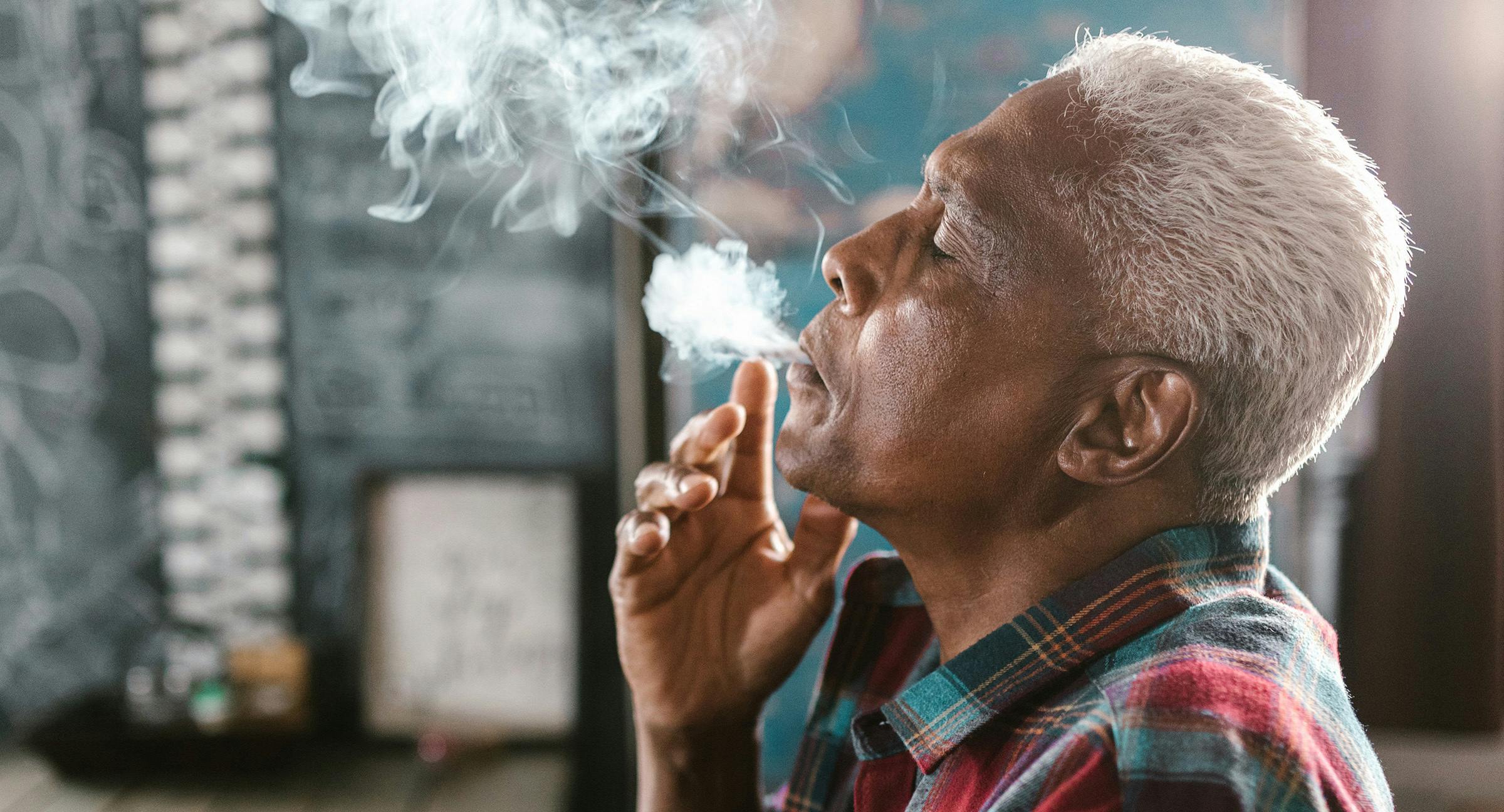 older man is seen smoking medical cannabis joint