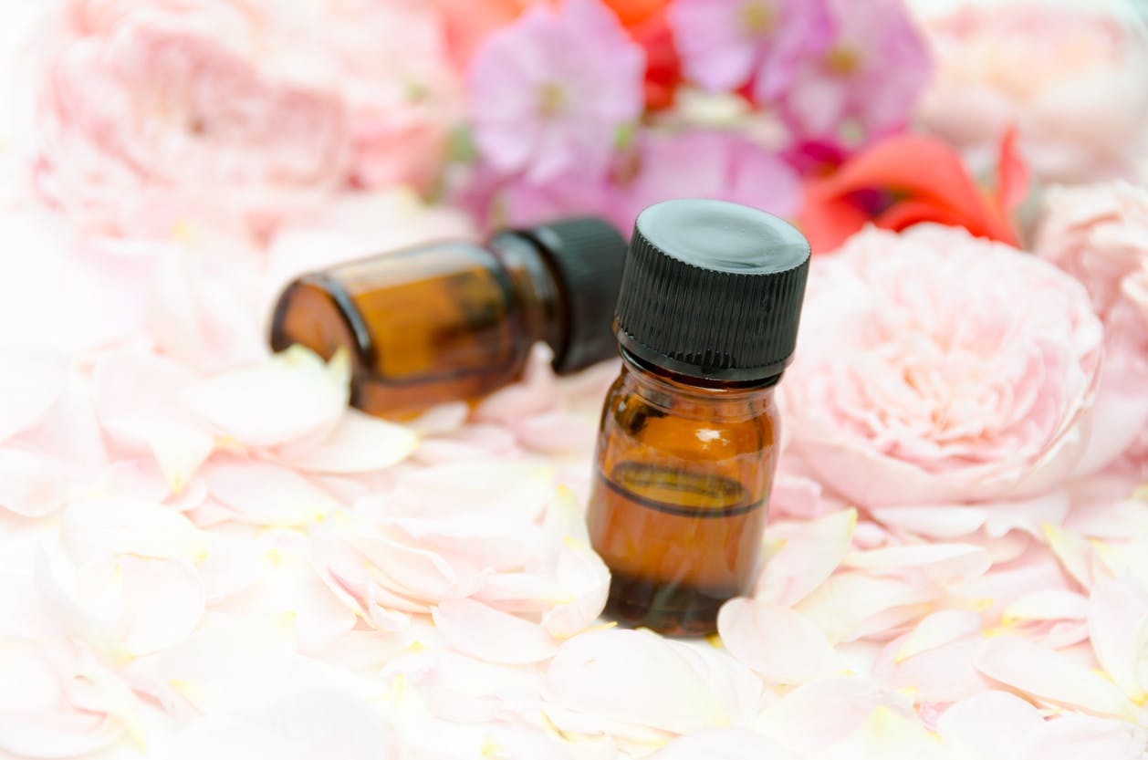 CBD massage oil for aromatherapy treatment with roses and the petals