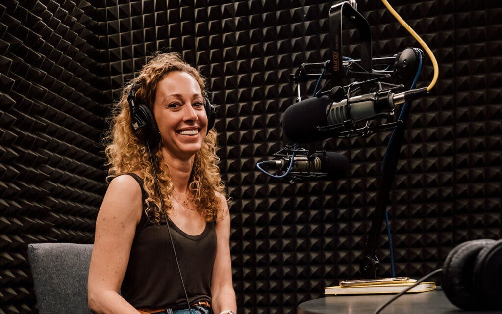 Picture of Ellen smiling in the podcast recording studio