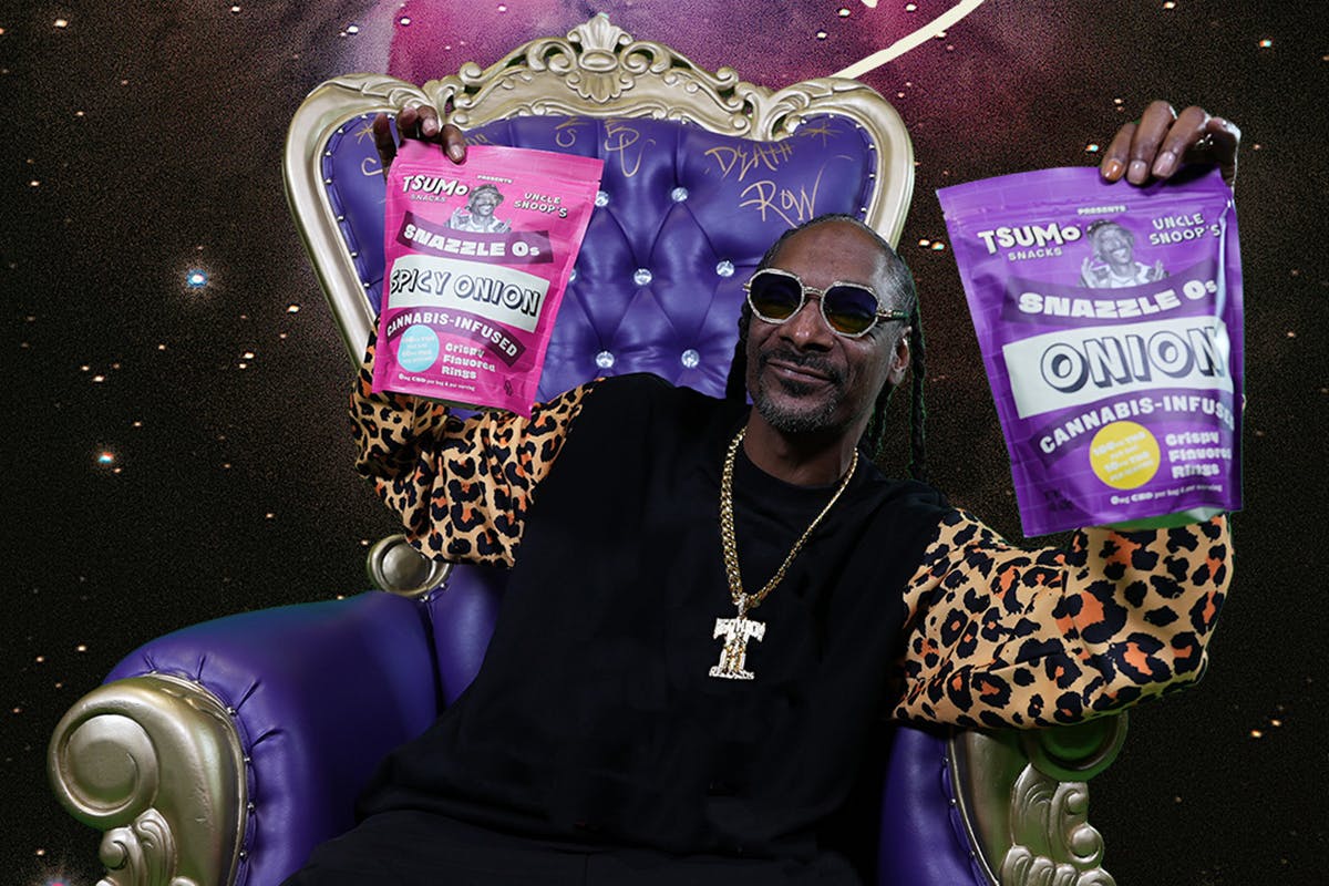 Snoop Dogg sitting on a throne holding TSUMo Snacks bags