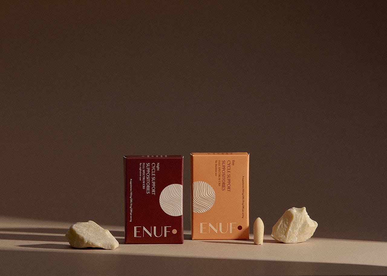 ENUF Period's night and day CBD suppositories product shot with dark brown background