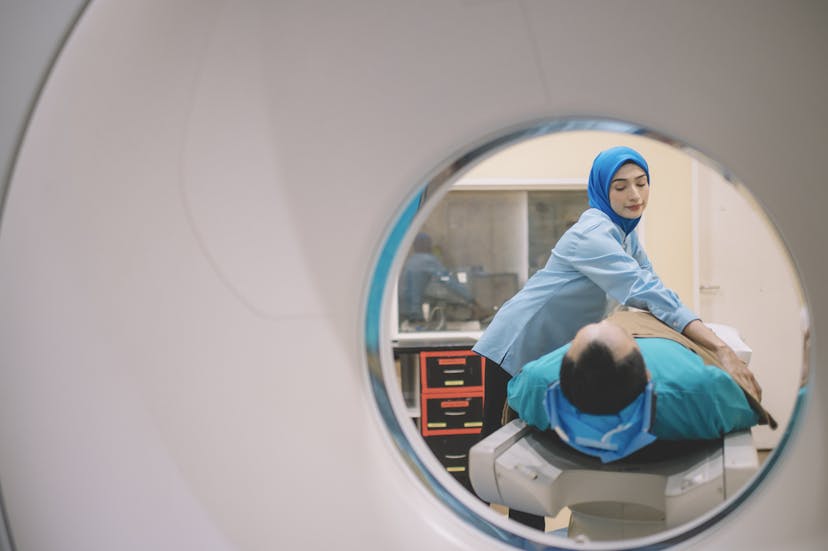 an asian malay male patient prepared for hospital CT Scan lying on the bed