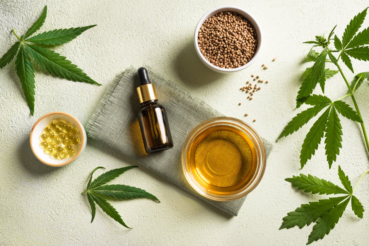 Hemp oil, leaves and seeds, cbd oil in bottle and capsules, alternative medicine and organic skin care concept.